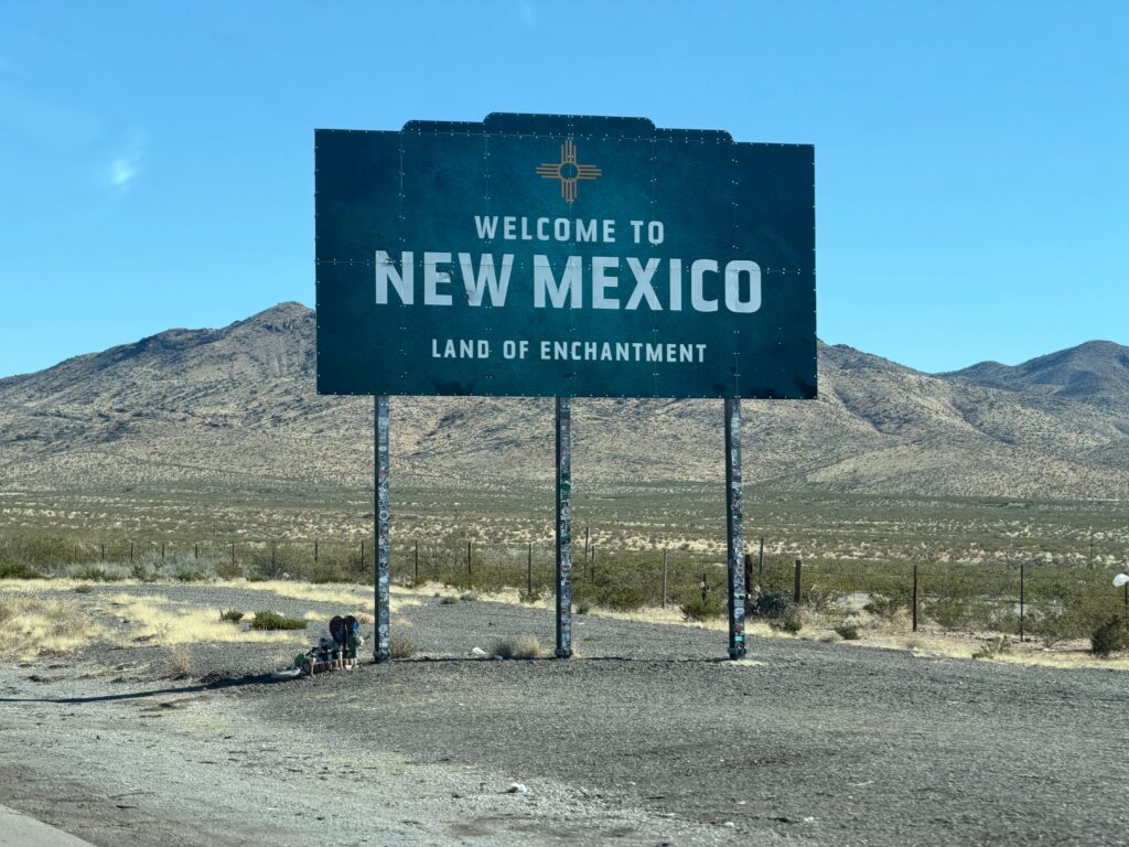 Iconic welcome sign for New Mexico in a desert landscape, tracing the state's enchanting charm.