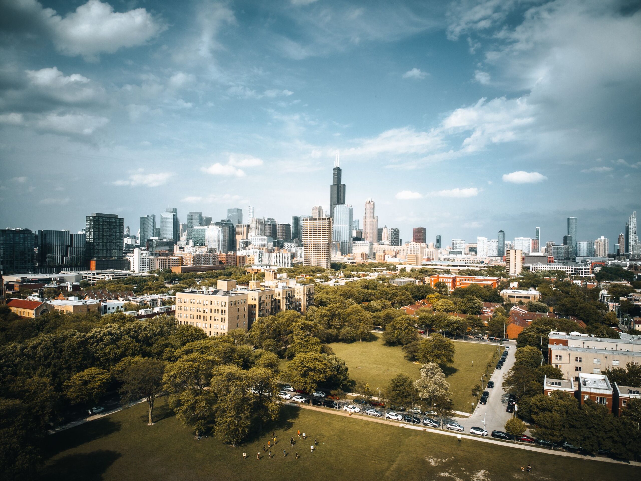 Stunning aerial shot of Chicago's skyline with visible Willis Tower under a blue sky.